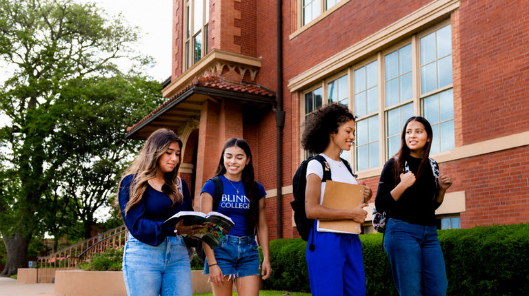 Three Students In Front of Old Main Building