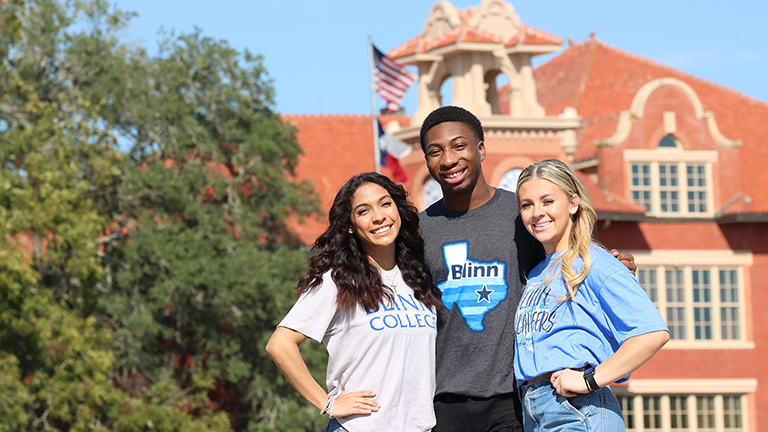 Three Students In Front of Old Main Building